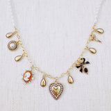 Gold-tone charm necklace featuring a mix of heart, bow, and angel motifs alongside vintage-style accents—blending sweet, romantic elements into a charming statement piece.