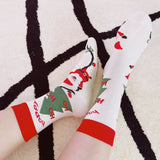 Set of three festive socks featuring holiday-themed designs, including Christmas colors and cheerful patterns, perfect for a cozy and jolly look.