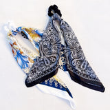 Set of two scrunchies featuring classic bandana scarf designs in nautical-inspired prints—combining style and function for a coastal, carefree look.