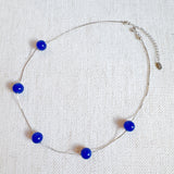 Elegant necklace featuring flowing indigo-toned beads—designed to capture graceful movement and add a touch of sophistication to any look.