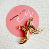 Statement earrings featuring bold interlocking loops in a polished gold-tone finish—offering a modern, sculptural look with standout appeal.