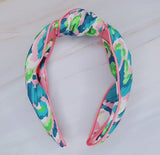 Knotted headband in tropical-inspired colors, evoking an island vacation feel.