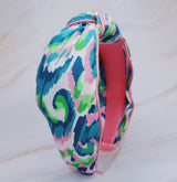 Knotted headband in tropical-inspired colors, evoking an island vacation feel.