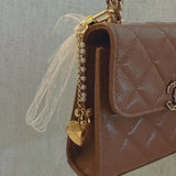 White lace ribbon bag charm with dangling gold heart charm – romantic vibe