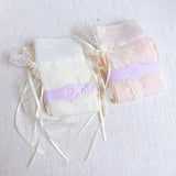 Set of two socks with lace detailing and satin bow accents at the back, offering a romantic and elegant touch to everyday looks.