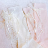 Set of two socks with lace detailing and satin bow accents at the back, offering a romantic and elegant touch to everyday looks.