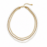 Set of three gold necklaces on a white background