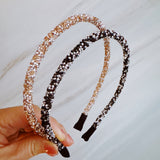 Set of two festive sparkle headbands in black and brown tones, each adorned with glittery “Let’s Celebrate” text and colorful accents, perfect for parties or special occasions.