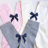 Set of three socks each featuring a charming bow detail on the back, adding a sweet and feminine accent to any look.