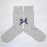 Set of three socks each featuring a charming bow detail on the back, adding a sweet and feminine accent to any look.