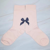 Set of three socks each featuring a charming bow detail on the back, adding a sweet and feminine accent to any look.