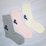 Set of three socks each featuring a charming bow detail on the back, adding a sweet and feminine accent to any look.