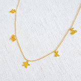 Gold-tone chain necklace featuring a playful mix of lucky-themed charms, including clovers, stars—perfect for adding a whimsical and personalized touch to any outfit.