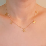 Gold-tone chain necklace featuring a playful mix of lucky-themed charms, including clovers, stars—perfect for adding a whimsical and personalized touch to any outfit.