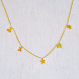 Gold-tone chain necklace featuring a playful mix of lucky-themed charms, including clovers, stars—perfect for adding a whimsical and personalized touch to any outfit.