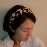 Chic and bold headband crafted from smooth satin fabric with a stylish leopard print—perfect for adding a touch of luxe and wild flair to any outfit.