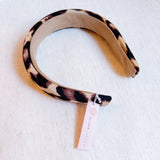 Chic and bold headband crafted from smooth satin fabric with a stylish leopard print—perfect for adding a touch of luxe and wild flair to any outfit.