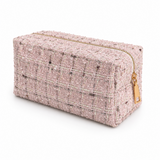 A mixed colors in pink, black, gold tweed fabric cosmetic case with gold zipper on white background