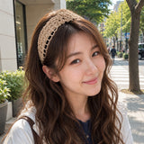 Woman wearing a beige headband on a city street