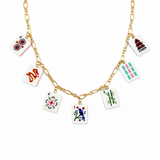 Gold necklace with playing card charm charms on a white background