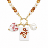 A beaded necklace with gold-tone chain and ring, featuring white and amber beads, a red floral bead, a white rectangular pendant with a red dragon motif, and a white pearl bead charm, shown on a white background.
