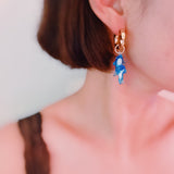 Dolphin-themed earrings featuring a dolphin design in a graceful, curved shape—perfect for a sweet, ocean-inspired look.
