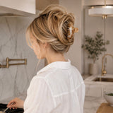 Woman with styled hair in a kitchen setting