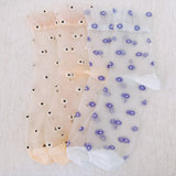 Set of two delicate sheer socks adorned with charming mini daisy patterns, offering a light and feminine touch to your everyday look.