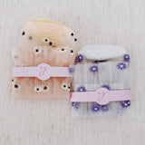 Set of two delicate sheer socks adorned with charming mini daisy patterns, offering a light and feminine touch to your everyday look.