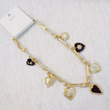 Gold-tone necklace featuring a collection of heart-shaped charms in black and gold finishes—creating a romantic, vintage-inspired statement with a bold, elegant touch.
