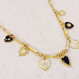 Gold-tone necklace featuring a collection of heart-shaped charms in black and gold finishes—creating a romantic, vintage-inspired statement with a bold, elegant touch.