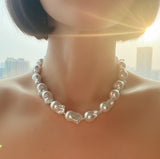 A bold statement necklace featuring genuine baroque pearls with their signature unique shapes, strung together with a gold clasp and adjustable extender chain