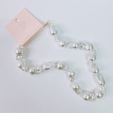 A bold statement necklace featuring genuine baroque pearls with their signature unique shapes, strung together with a gold clasp and adjustable extender chain