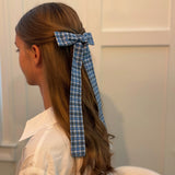 Hair clip featuring a classic preppy plaid bow design, adding a charming and polished touch to any hairstyle.