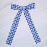 Hair clip featuring a classic preppy plaid bow design, adding a charming and polished touch to any hairstyle.