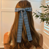 Hair clip featuring a classic preppy plaid bow design, adding a charming and polished touch to any hairstyle.