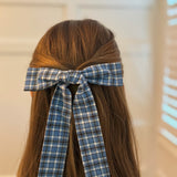 Hair clip featuring a classic preppy plaid bow design, adding a charming and polished touch to any hairstyle.