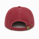 Red baseball cap with a brown strap on a white background