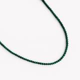 Single strand necklace featuring natural stone beads in warm, earthy tones with subtle color variations and organic shapes, offering a bohemian and grounded look perfect for everyday wear or layering.