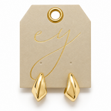 A pair of polished gold geometric drop earrings displayed on a beige branded jewelry tag with gold foil lettering, set against a clean white background.