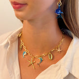 Gold necklace with starfish, shell, and colorful ocean-themed charms
