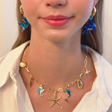 Gold necklace with starfish, shell, and colorful ocean-themed charms
