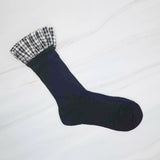 Elegant plaid socks featuring delicate ruffle trim at the top—combining classic style with a chic, feminine twist.