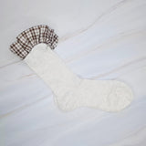 Elegant plaid socks featuring delicate ruffle trim at the top—combining classic style with a chic, feminine twist.