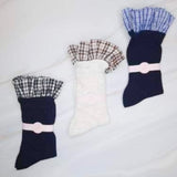 Elegant plaid socks featuring delicate ruffle trim at the top—combining classic style with a chic, feminine twist.