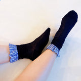 Elegant plaid socks featuring delicate ruffle trim at the top—combining classic style with a chic, feminine twist.