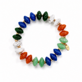 A beaded stretch bracelet featuring polished oval beads in blue, green, orange, and white, separated by small gold spacer beads, with a small gold charm on a white background.