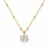 white background, sided oval cut sparkly diamond looking pendant with yellow gold chain.