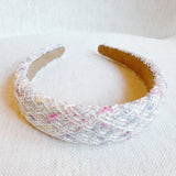 Elegant headband crafted from soft pastel tweed fabric with subtle texture and charm—perfect for a polished, feminine look with a hint of vintage flair.