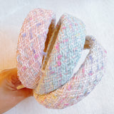 Elegant headband crafted from soft pastel tweed fabric with subtle texture and charm—perfect for a polished, feminine look with a hint of vintage flair.